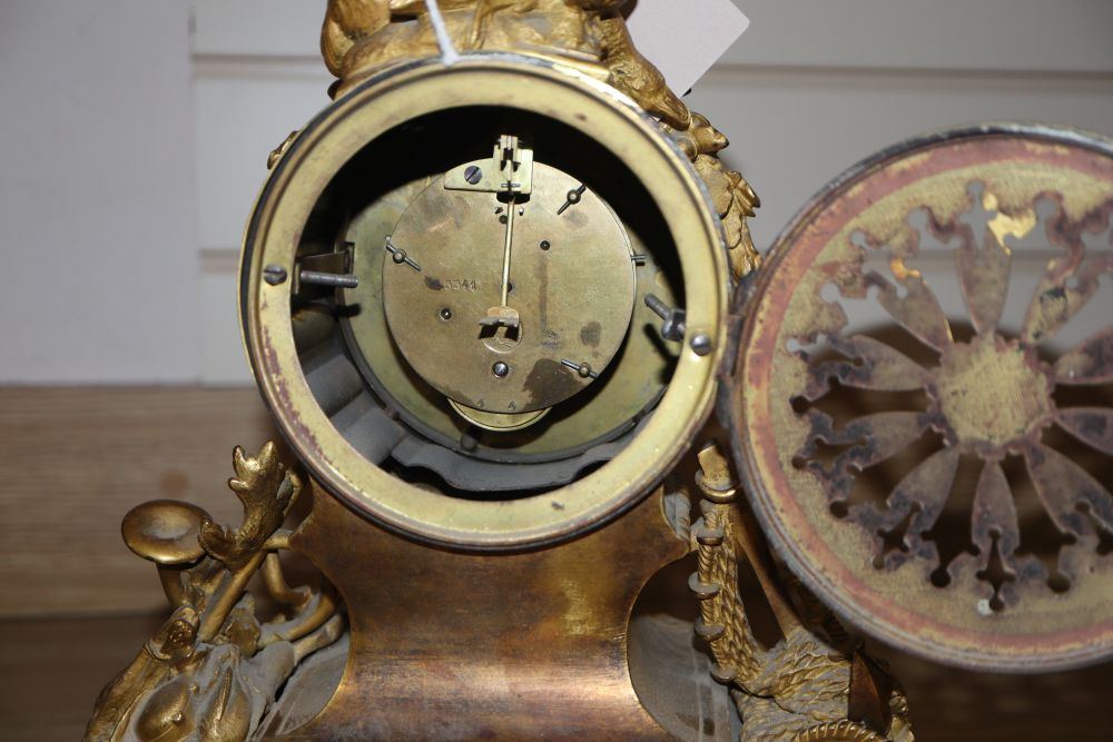 A 19th century French Louis XVI style ormolu mantel clock and a pair of associated spelter table lamps,